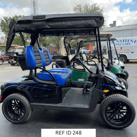 2021 black E-Z-GO RXV Elite golf cart with custom two-tone seats, custom enclosure, and 14-inch wheels