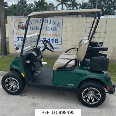 2025 E-Z-GO RXV Freedom Elite golf cart in green with 12-inch wheels, premium seats, Sunbrella enclosure, fan, windshield, mirrors, USB port, LED lights, and Samsung Lithium battery