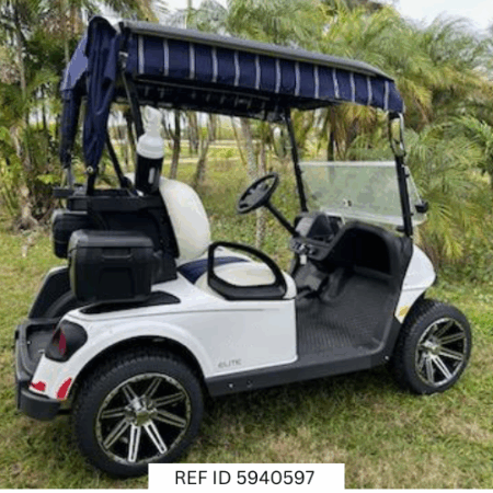 2026 E-Z-GO RXV Freedom Elite golf cart in bright white with 14-inch wheels, premium seats, windshield, and Samsung Lithium battery